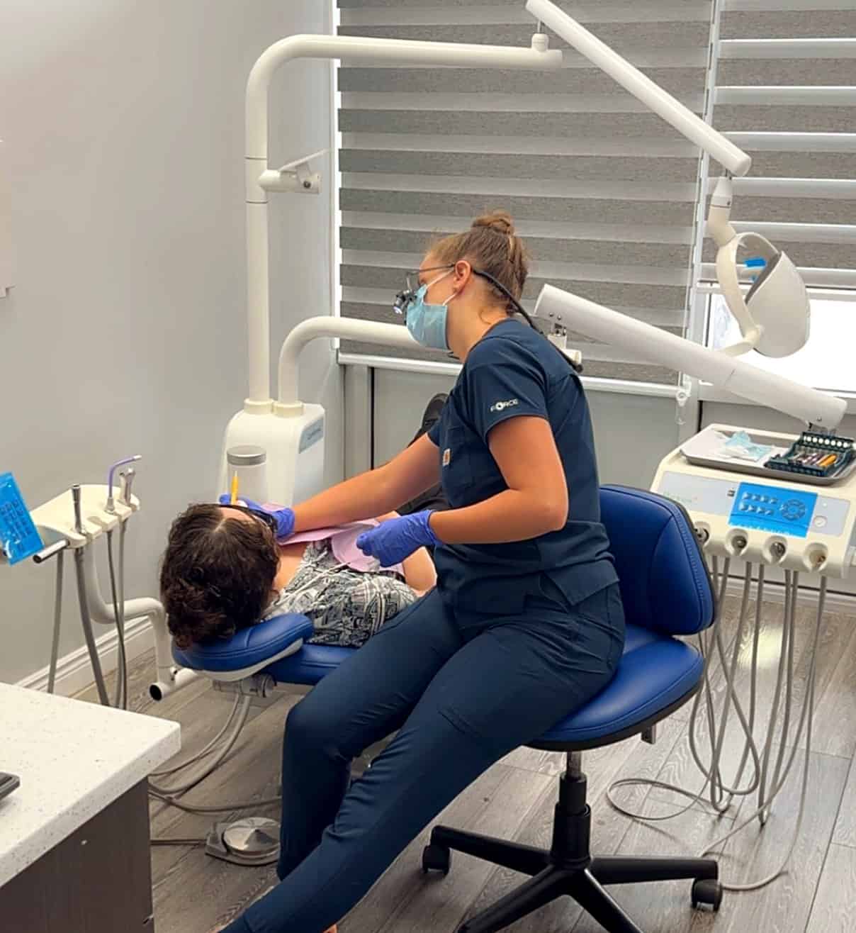 Dental hygienist cleaning a patient’s teeth at Rose City Dental in Windsor, Ontario
